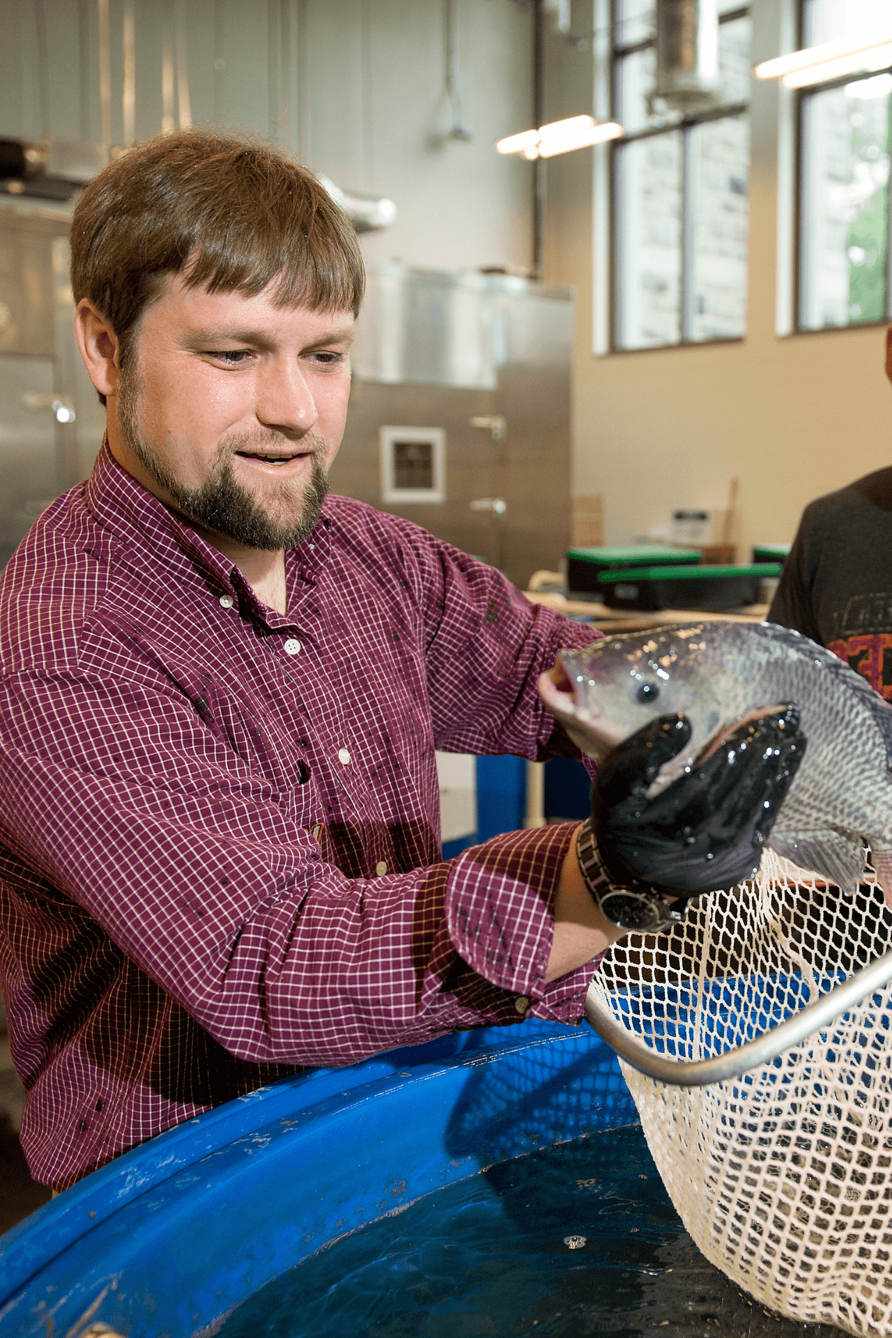 A researcher holds up a fish