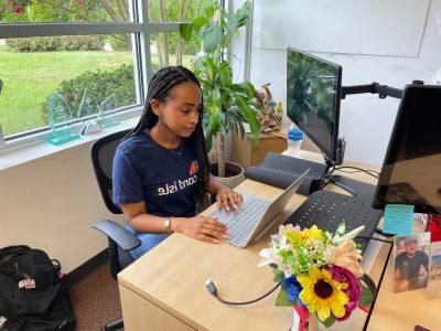 Federal work-study student MIeraf Teshome does work on a laptop for her employer, Card Isle.