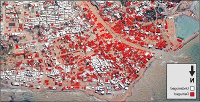 Google Earth image of buildings in the Wadi Derna River Valley. A large number of them are color-coded red.